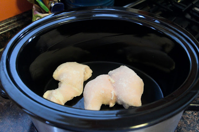 Frozen chicken breasts in the crock pot.
