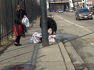 A couple struggles to get their groceries down the street to home
