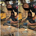 Nigerian Police Officer Spotted Repairing His Gun At A Welder's Workshop - Photos