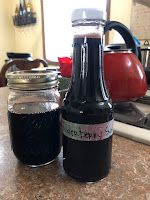 elderberry syrup in pouring jar and mason jar