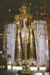 standing wooden Buddha statue