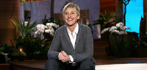 Ellen Degeneres smiling with plants in background