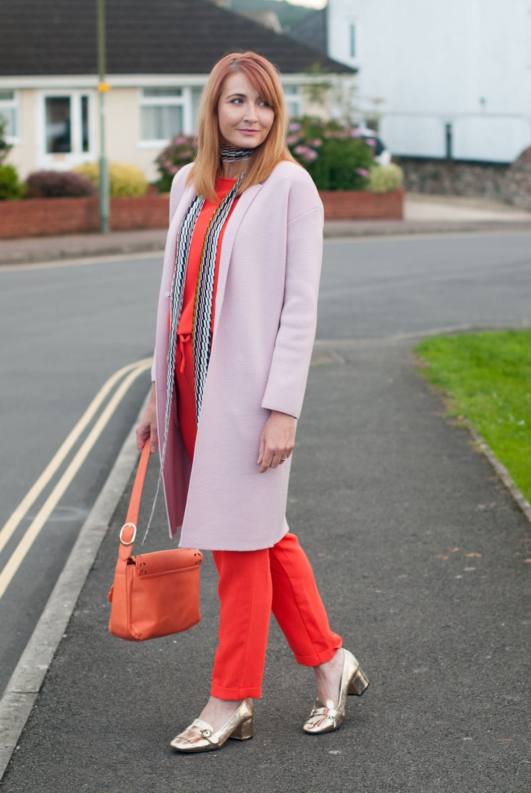 Ways to wear an orange jumpsuit: With a longline pink coatigan, metallic gold block heel loafers, 70s style skinny scarf | Not Dressed As Lamb, over 40 style Ways to wear an orange jumpsuit: With a longline pink coatigan, metallic gold block heel loafers, 70s style skinny scarf | Not Dressed As Lamb, over 40 style
