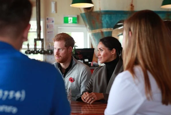 Meghan Markle wore Club Monaco Ellayne trench coat, Stuart Weitzman Veruka suede boots and Outland Denim Harriet Jeans