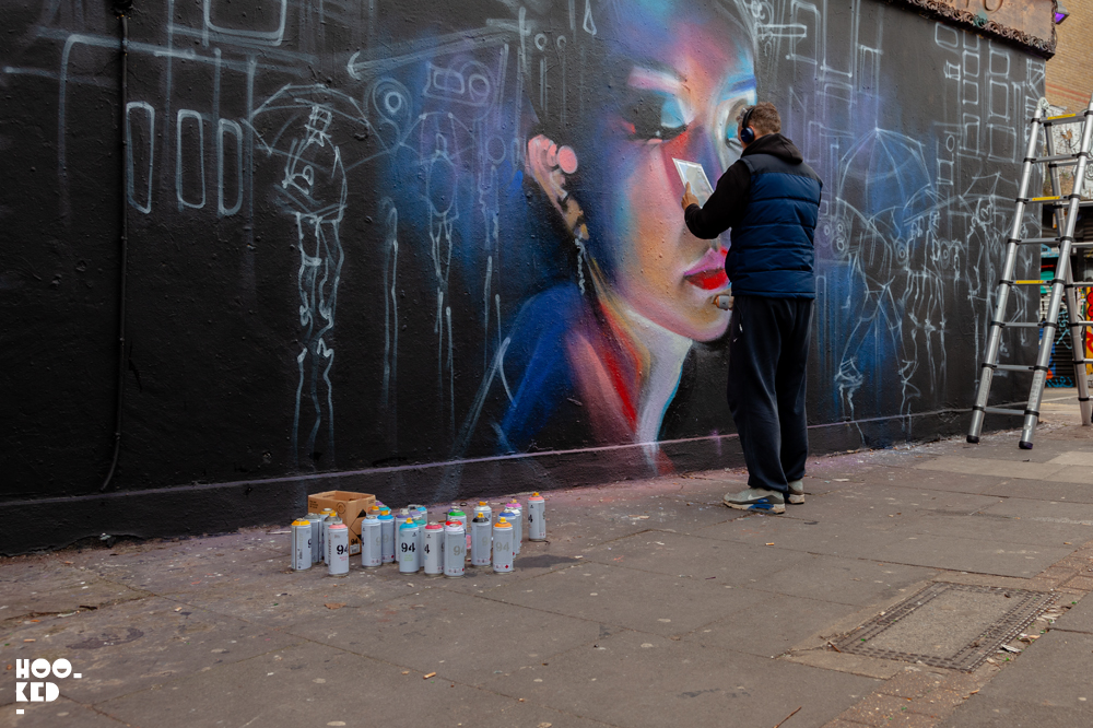 Shoreditch Street Art, London Street Artist Dan Kitchener aka DANK at work on a mural Shoreditch Street Art, London Street Artist Dan Kitchener aka DANK at work on a mural