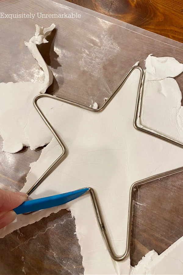 Cutting A Star from wire Mold with a blue knife