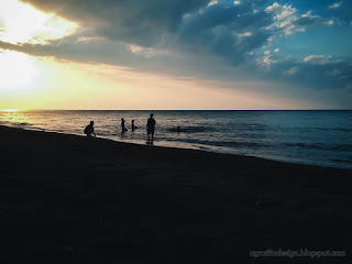 Evening Sunshines On The Beach With Boys Bathing And Playing On Calm Sea Waves At Umeanyar Village North Bali Indonesia