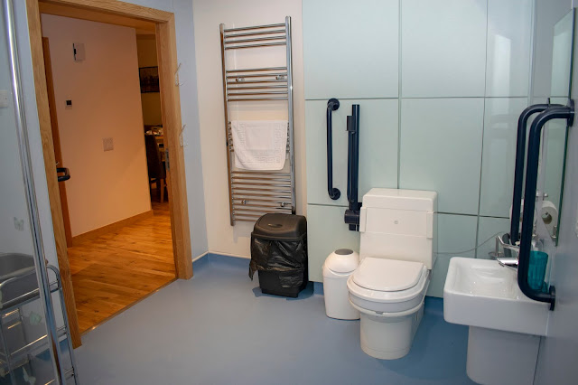 Other side of wet room with toilet, sink and towel heater