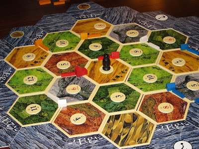Settlers of Catan - The basic layout early in the game & my red territories are already being blighted by the robber