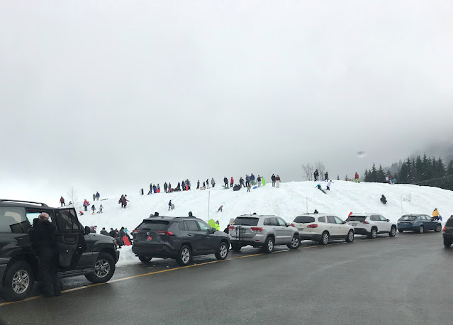 An increase in people looking for winter recreation has led to a dangerous increase in vehicles parking alongside a highway and sledding on interchanges right next to the road.