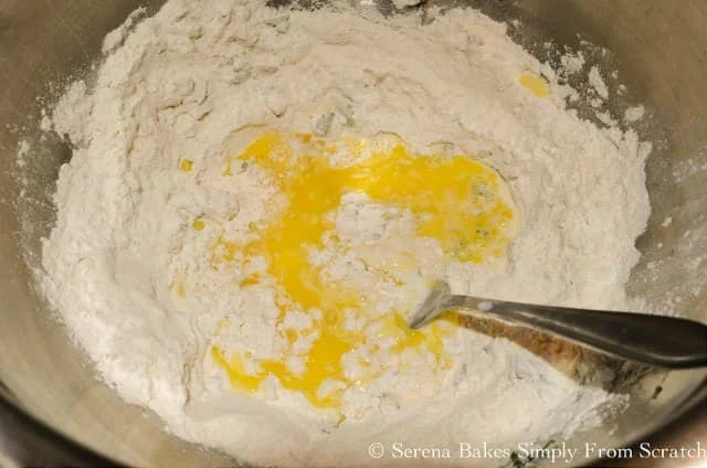 Flour, baking powder, salt, fresh herbs with a well in center with beaten egg, milk, and melted butter for Dumplings.