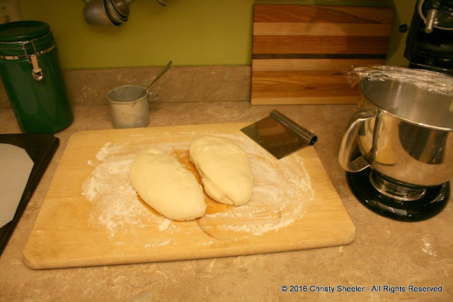 The dough has been split in two for forming pizzas.