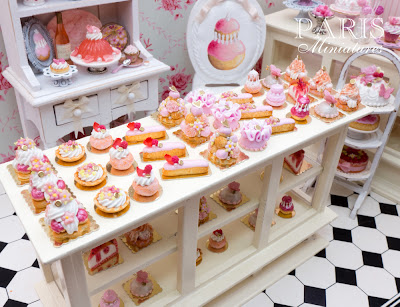Individual pink pastries in 12th in a miniature pâtisserie setting