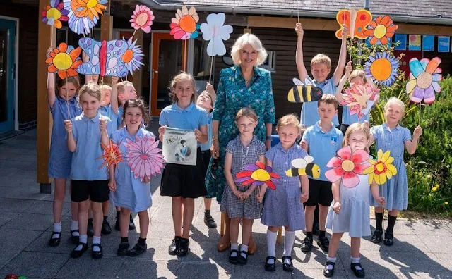 The Duchess wore a hawaiian summery print turquoise blue shirt dress. Prince Charles and Camilla met schoolchildren in St Mary