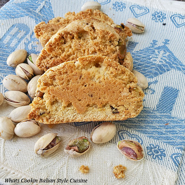 Pistachio Almond Biscotti Pistachio Almond Biscotti on a blue dish towel that came from Rome Italy is in the photo along with shelled roasted pistachio nuts. These are cookies that are a gourmet style in Italy called pistachio biscotti