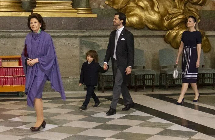 Queen Silvia wore a purple dress and cape from Georg Et Arend. Prince Alexander, Erik Hellqvist, Marie Hellqvist and Lina Hellqvist