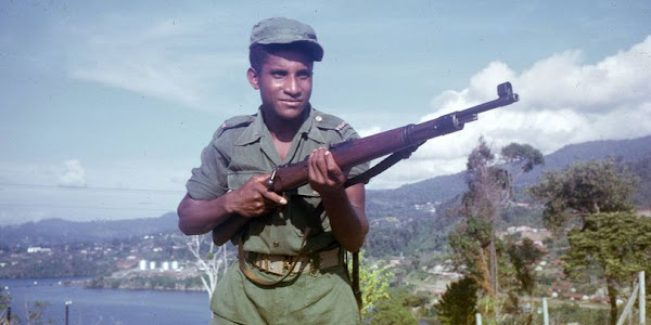 Officer Of The Papuan Police. In The Background The Capital City Hollandia. Dutch New Guinea (1961)
