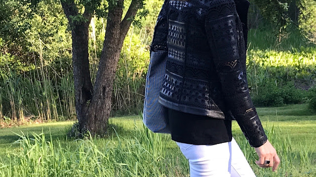 Black bomber and white jeans