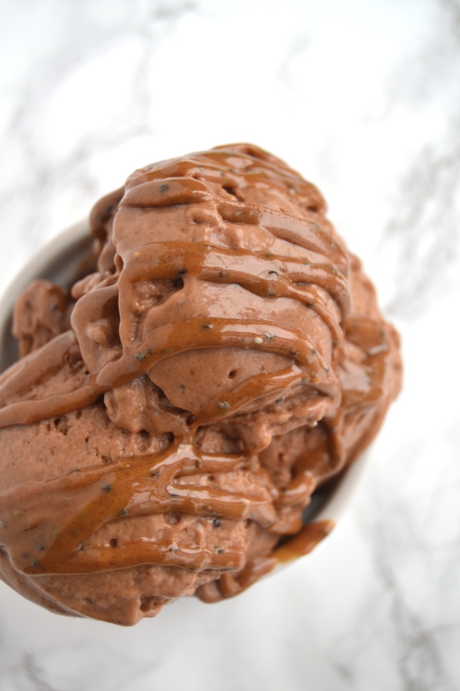 Chocolate Peanut Butter Banana Ice Cream is made with 4-ingredients: frozen bananas, peanut butter, cocoa powder and milk, takes 2 minutes to make and is super rich and creamy for the perfect dessert! www.nutritionistreviews.com