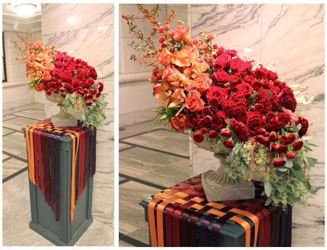 Detroit Institute of arts floral design arrangement  in stone urn ombre fall gem tones deep red burgundy rust orange roses orchids sweet pea floral design Holly Rutt woven ribbon ombre cascade roses st. Therese feast day