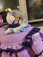 Doll in lavender crocheted pillow dress usually lives in the suitcase. She will be bummed to be cooped up all summer instead of lurking free while the suitcase travels