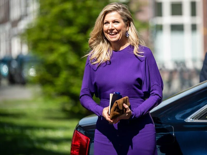 Queen Maxima wore a puffled sleeves dolman midi dress from Victoria Beckham, and yellow floral print silk satin dress from Natan