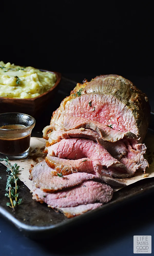Gather the family around for #SundaySupper to enjoy this beautiful Garlic Roast Beef | by Life Tastes Good. With a crisp garlicky crust on the outside and juicy inside, this elegant meal is special enough for holidays! #LTGrecipes #SundaySupper #RoastPerfect