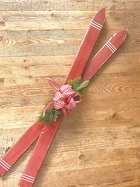 Red skis with a bow and greenery