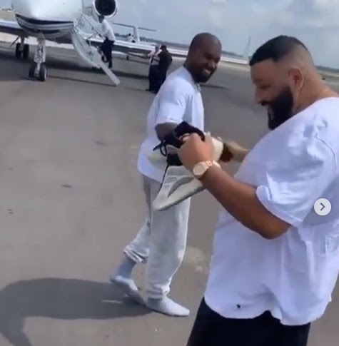 Kanye West takes off his unreleased Yeezy sneakers and gifts to DJ Khaled before they both walk off to their respective private jets (video)