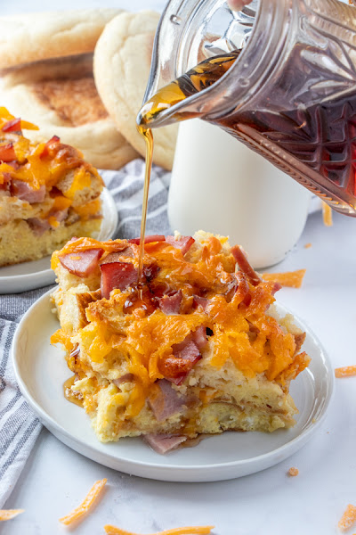 This delicious breakfast casserole has all the ingredients of McDonald's Egg McMuffins combined together and baked! Use Canadian bacon, sausage or regular bacon, and any cheese you prefer! Drizzle maple syrup on top for that delicious sweet and savory flavor combo! Make this for holiday brunch or dinner instead of breakfast!