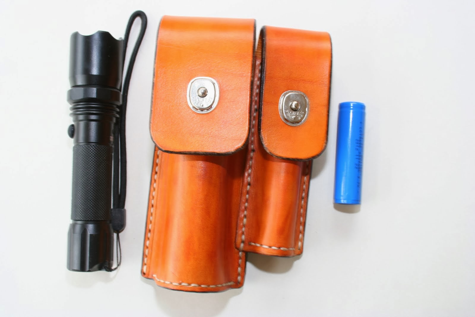 Combination torch and battery belt pouch