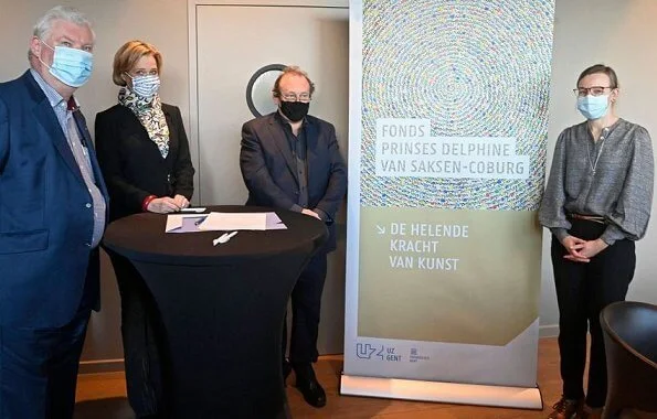 Princess Delphine of Belgium wore a black belted blazer and silk satin print scarf from Saxe-Coburg. Professor Tessa Kerre is president of the fund