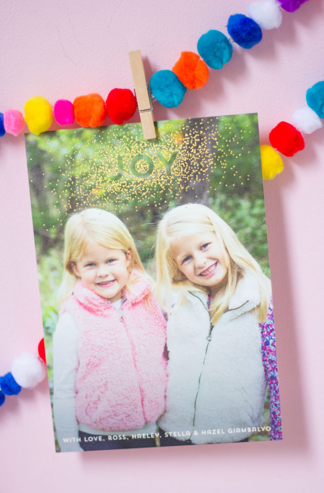 Love this colorful Christmas card display idea with pom-pom garlands!