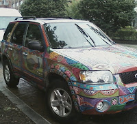 view of front of car showing paisley-type bright colored designs all over car