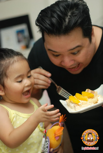 father and daughter eating cake