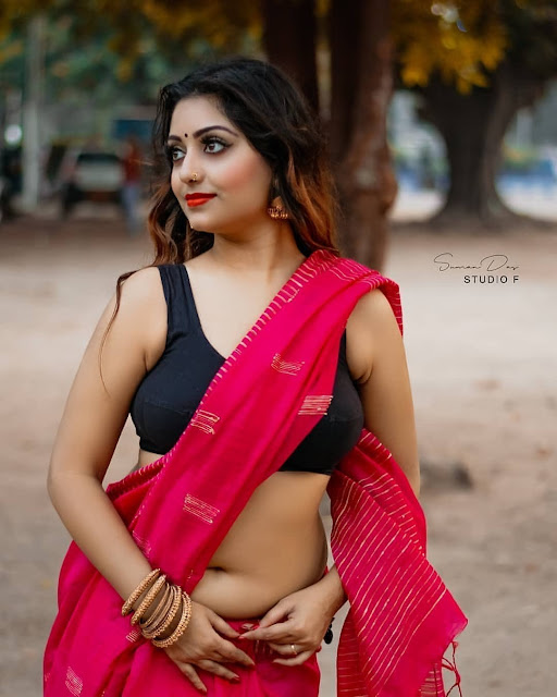 Rupsa Saha Chowdhury poses in a crimson saree with a black sleeveless blouse Navel Queens