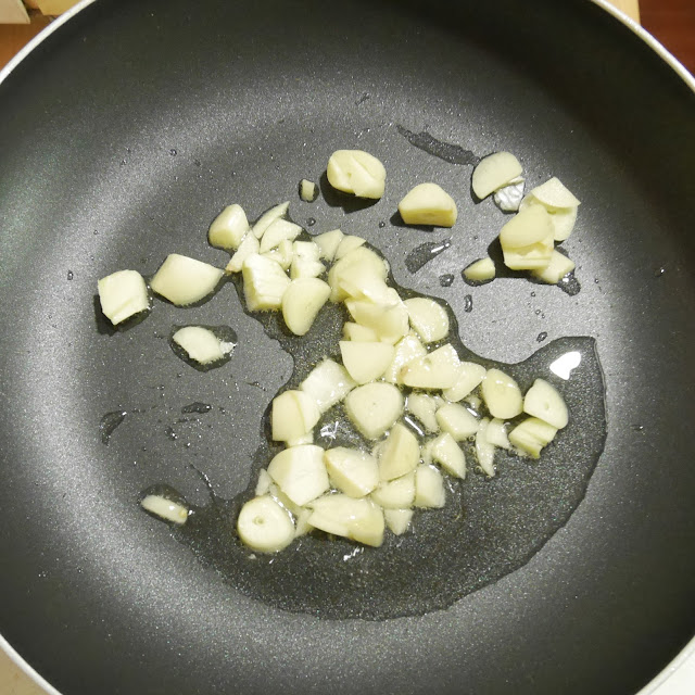 garlic frying in oil in a frying pan