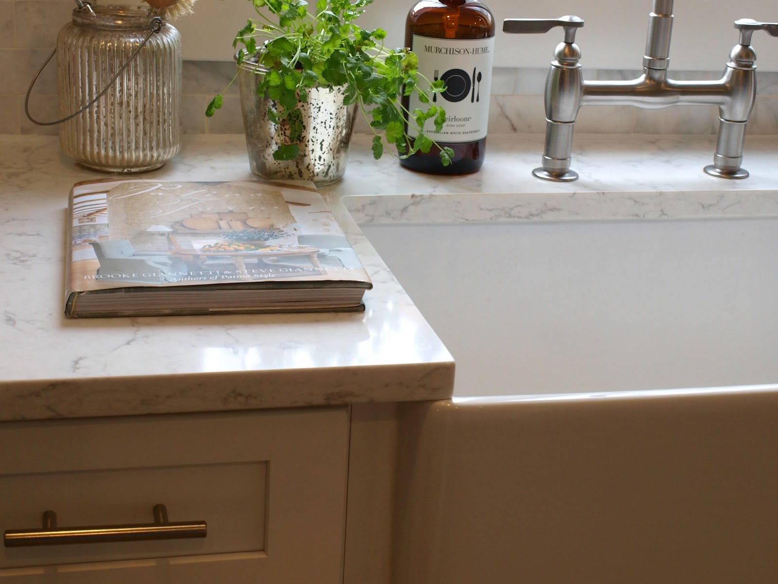 Inspiring and beautiful white modern farmhouse kitchen design by Hello Lovely Studio. Viatera Minuet quartz countertops, farm sink, and marble subway backsplash tile. #farmsink #minuet #quartz