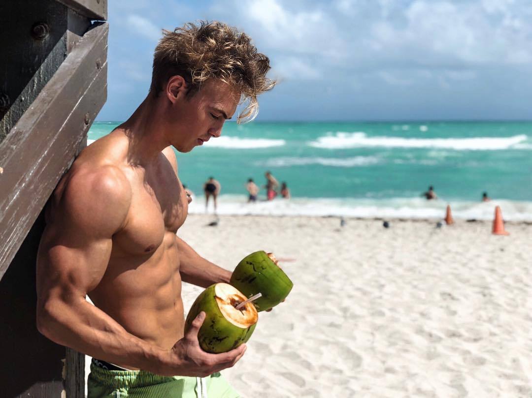 hot-shirtless-fit-beach-guy-drinking-coconut