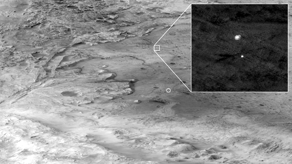 NASA's Perseverance rover--still encased inside its aeroshell and under a parachute while approaching its landing site at Mars' Jezero Crater--as seen by the Mars Reconnaissance Orbiter 700 kilometers (435 miles) away in space...on February 18, 2021. NASA's Perseverance rover--still encased inside its aeroshell and under a parachute while approaching its landing site at Mars' Jezero Crater--as seen by the Mars Reconnaissance Orbiter 700 kilometers (435 miles) away in space...on February 18, 2021.