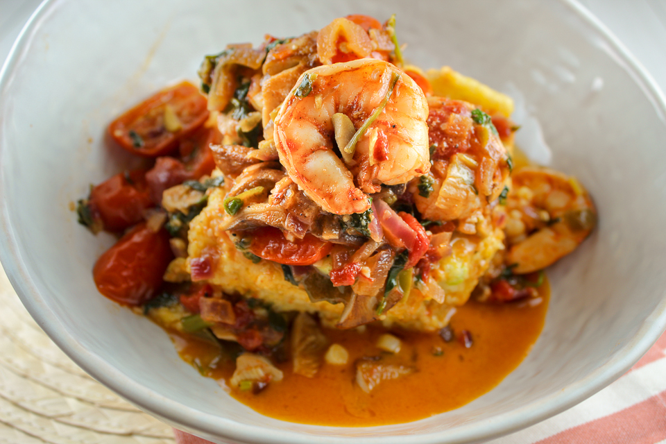 This Shrimp and Grits with Spinach & Tomatoes is a dish that will impress your friends and family! It is as delicious as it is beautiful! These cheesy grit cakes are smothered with jumbo shrimp, sauteed mushrooms, tomatoes and spinach. 