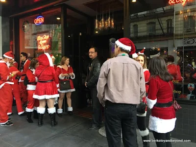 Santacon 2017 participants lined up at Sam's Cable Car Lounge in San Francisco