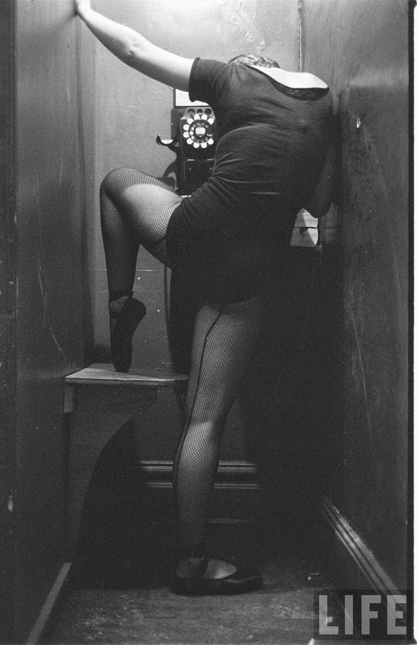 Mary Ellen Terry Talking With Her Legs Up in a Telephone Booth in 1952.