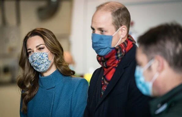 Kate Middleton wore a khaki coat and tartan scarf from Alexander McQueen, and blue coat and black gloves from Catherine Walker. Meghan Markle