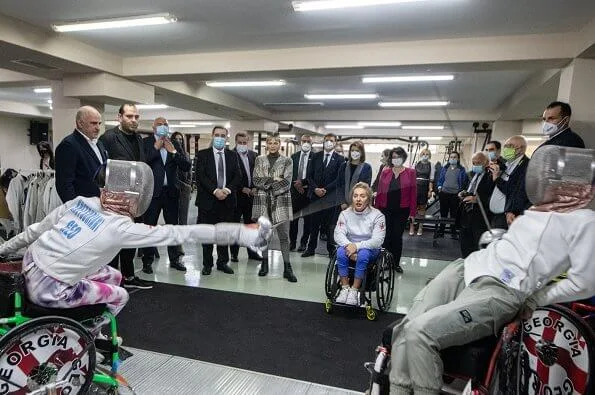 Princess Charlene visited the Olympic Village in Tbilisi and its sports facilities. Charlene wore a traford plaid fringe poncho from Loro Piana