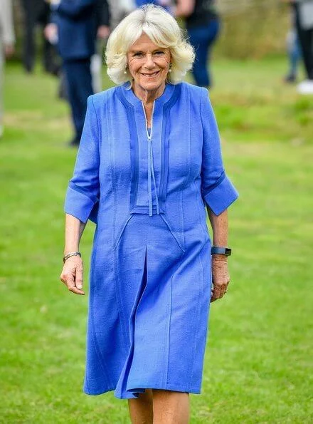 Duchess of Cornwall, Patron of Community First, visited Oxenwood Outdoor Education Centre. She wore a blue summer dress and pearl earrings