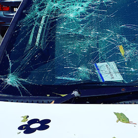 Close up of a car windscreen covered in cracks.