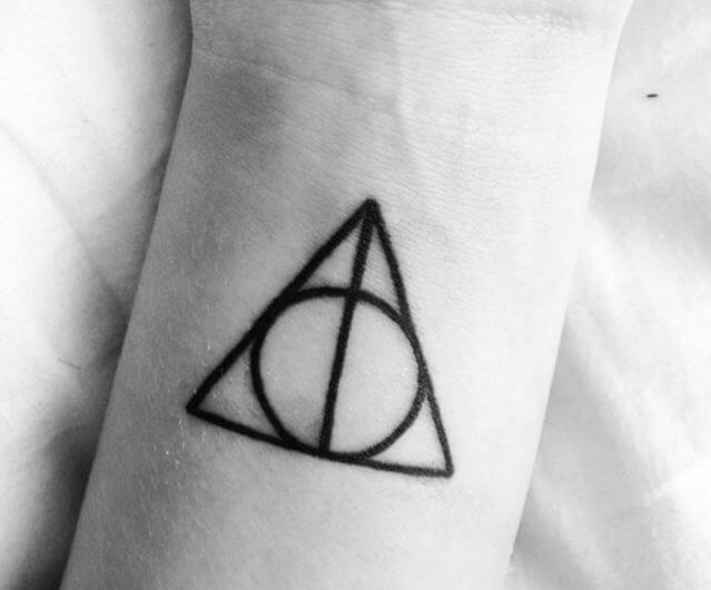 3. "Triangle tattoo with circle and line" - wide 3