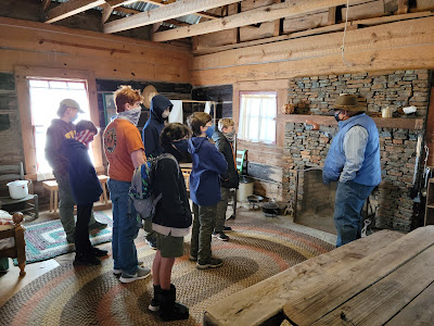 Dr. Mitchell explains how the fireplace was a central element to pioneer life. It was where families gathered, socialized, found warmth and cooked.