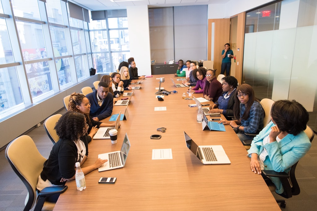 people sitting around conference table